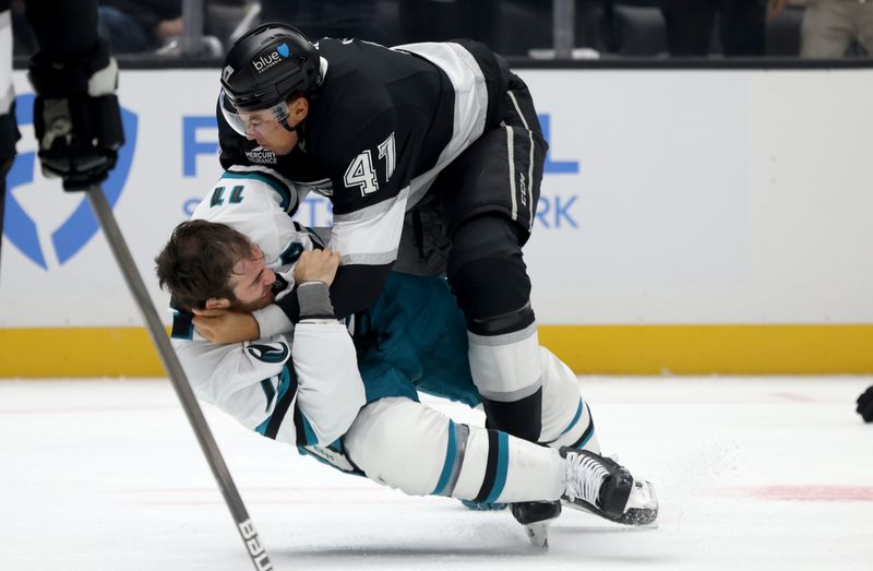 Oct 24, 2024; Los Angeles, California, USA; Los Angeles Kings left wing Andre Lee (47) and San Jose Sharks center Luke Kunin (11) fight during the first period at Crypto.com Arena. Mandatory Credit: Jason Parkhurst-Imagn Images