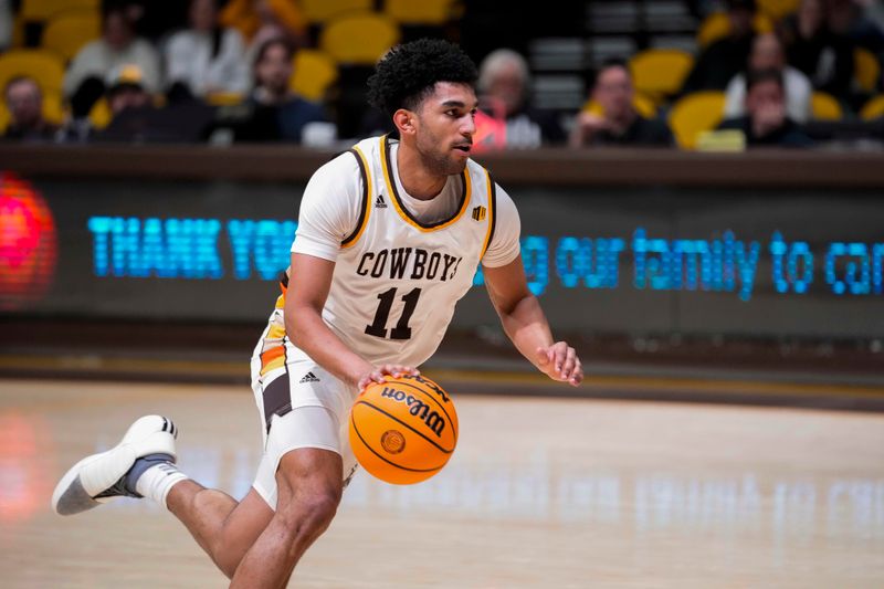 Feb 27, 2024; Laramie, Wyoming, USA; Wyoming Cowboys guard Kael Combs (11) drives against the UNLV Runnin' Rebels during the first half at Arena-Auditorium. Mandatory Credit: Troy Babbitt-USA TODAY Sports