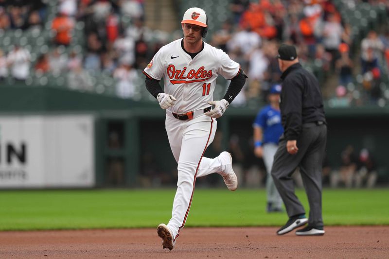 May 15, 2024; Baltimore, Maryland, USA; Baltimore Orioles third baseman Justin Westburg (11) connects on a solo home run in the first inning at Oriole Park at Camden Yards. Mandatory Credit: Mitch Stringer-USA TODAY Sports