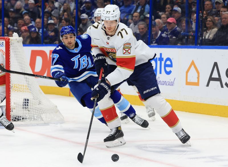 Feb 5, 2026; Tampa, Florida, USA; Florida Panthers defenseman Niko Mikkola (77) skates against Tampa Bay Lightning center Dominic James (17) during the first period at Benchmark International Arena. Mandatory Credit: Kim Klement Neitzel-Imagn Images
