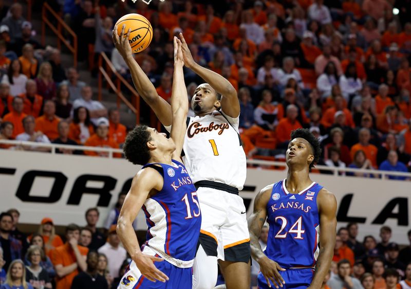 Feb 14, 2023; Stillwater, Oklahoma, USA; Oklahoma State Cowboys guard Bryce Thompson (1) shoots as Kansas Jayhawks guard Kevin McCullar Jr. (15) defends the shot during the first half at Gallagher-Iba Arena. Mandatory Credit: Alonzo Adams-USA TODAY Sports