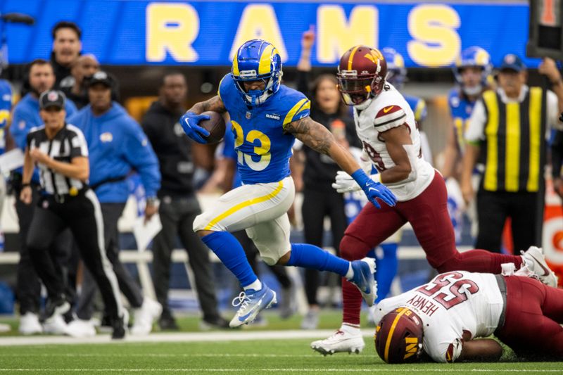 Los Angeles Rams running back Kyren Williams (23) runs with the ball past Washington Commanders defensive end KJ Henry (55) during an NFL football game, Sunday, Dec. 17, 2023, in Inglewood, Calif. (AP Photo/Kyusung Gong)