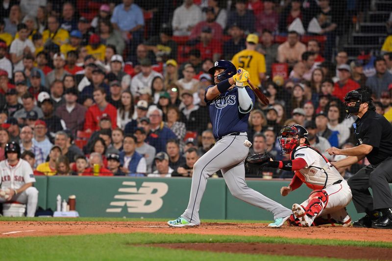 May 15, 2024; Boston, Massachusetts, USA; Tampa Bay Rays third baseman Isaac Paredes (17) hits a single against the Boston Red Sox during the fourth inning at Fenway Park. Mandatory Credit: Eric Canha-USA TODAY Sports