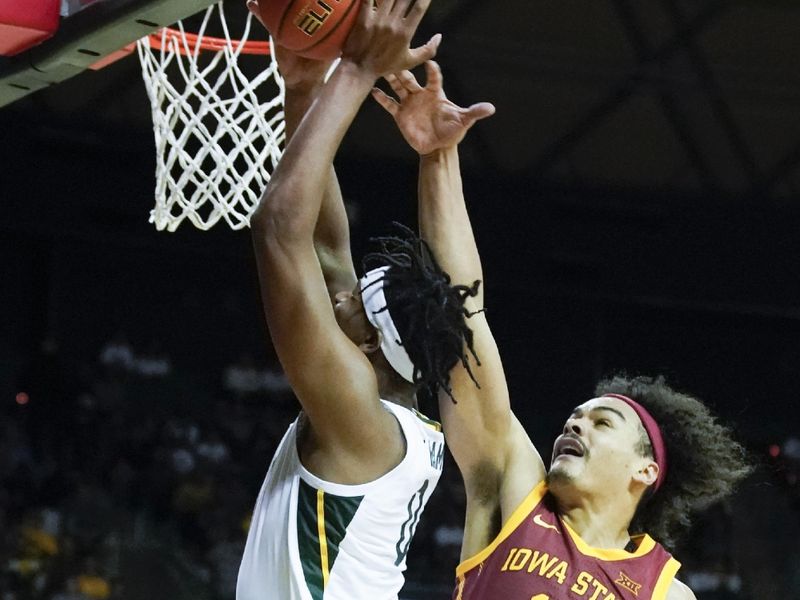 Mar 4, 2023; Waco, Texas, USA; Baylor Bears forward Flo Thamba (0) shoots the ball against Iowa State Cyclones forward Robert Jones (12) during the second half at Ferrell Center. Mandatory Credit: Raymond Carlin III-USA TODAY Sports