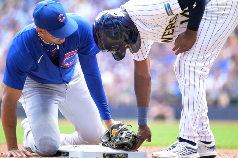 Jun 29, 2024; Milwaukee, Wisconsin, USA; Chicago Cubs third base Christopher Morel (5) is late with the tag on Milwaukee Brewers second base Andruw Monasterio (14) in the third innin  at American Family Field. Mandatory Credit: Michael McLoone-USA TODAY Sports