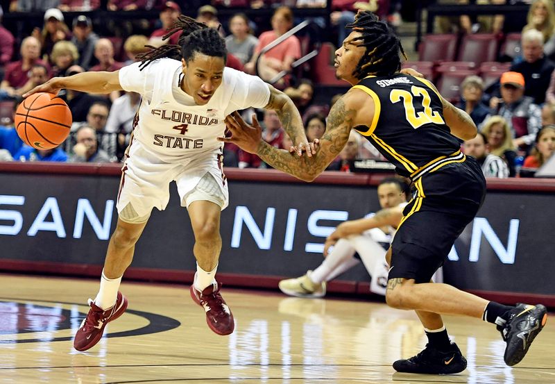 Feb 11, 2023; Tallahassee, Florida, USA; Florida State Seminoles guard Caleb Mills (4) drives the ball past the defense of Pittsburgh Panthers guard Nike Sibande (22) during the second half at Donald L. Tucker Center. Mandatory Credit: Melina Myers-USA TODAY Sports