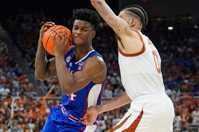 Mar 4, 2023; Austin, Texas, USA; Kansas Jayhawks forward KJ Adams Jr. (24) drives to the basket while defended by Texas Longhorns forward Timmy Allen (0) during the second half at Moody Center. Mandatory Credit: Scott Wachter-USA TODAY Sports