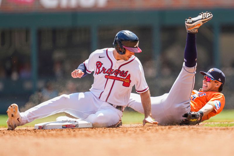 Apr 23, 2023; Cumberland, Georgia, USA; Atlanta Braves first baseman Matt Olson (28) takes out Houston Astros second baseman Mauricio Dubon (14) causing an error on a throw during the sixth inning at Truist Park. Mandatory Credit: Dale Zanine-USA TODAY Sports