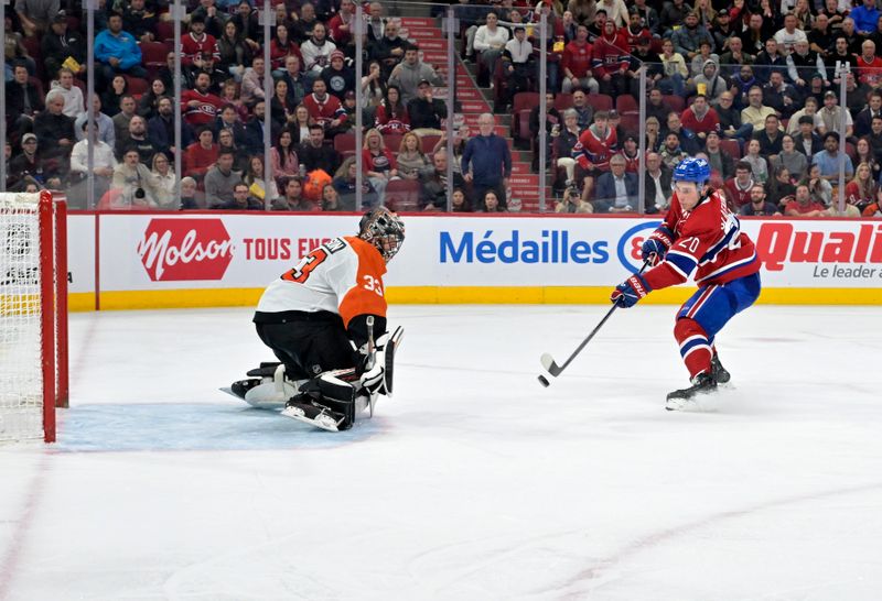 Apr 9, 2024; Montreal, Quebec, CAN; Montreal Canadiens forward Juraj Slafkovsky (20) scores his third goal of the game against Philadelphia Flyers goalie Samuel Ersson (33) during the second period at the Bell Centre. Mandatory Credit: Eric Bolte-USA TODAY Sports