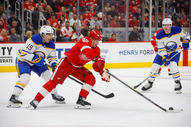 Nov 2, 2024; Detroit, Michigan, USA; Detroit Red Wings right wing Patrick Kane (88) handles the puck against Buffalo Sabres center Peyton Krebs (19) during the second period of the game at Little Caesars Arena. Mandatory Credit: Brian Bradshaw Sevald-Imagn Images