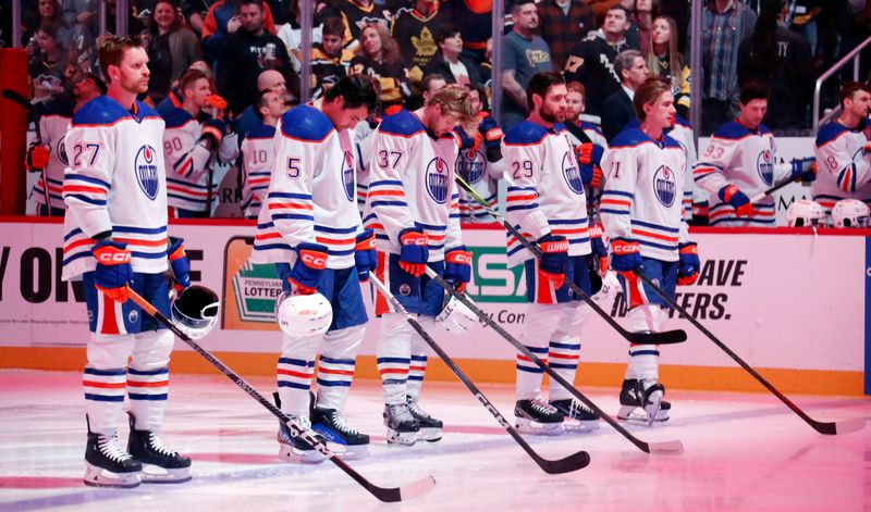 Mar 10, 2024; Pittsburgh, Pennsylvania, USA;  The Edmonton Oilers starting lineup (L to R) defenseman Brett Kulak (27) and defenseman Cody Ceci (5) and left wing Warren Foegele (37) and center Leon Draisaitl (29) and center Ryan McLeod (71) stand for the national anthem against the Pittsburgh Penguins at PPG Paints Arena. The Oilers won 4-0. Mandatory Credit: Charles LeClaire-USA TODAY Sports