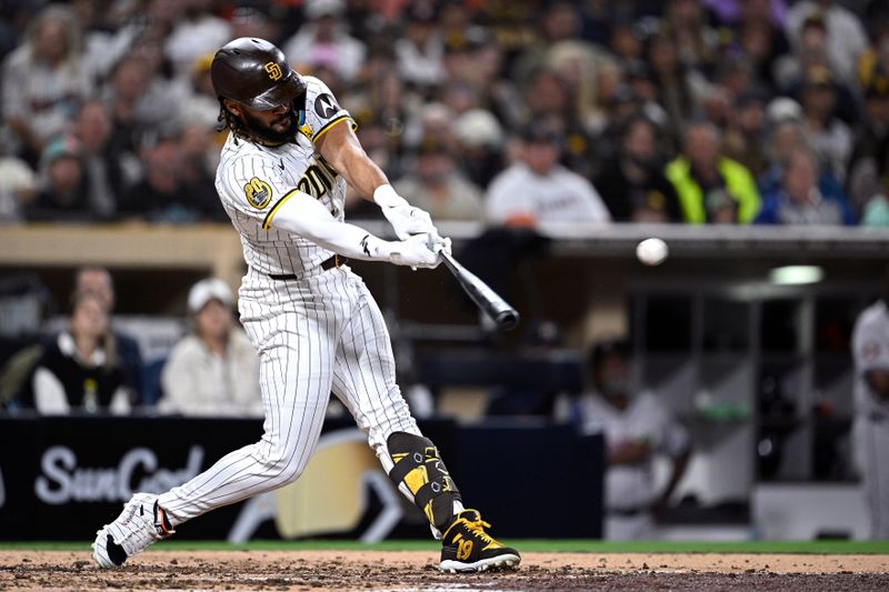 Sep 16, 2024; San Diego, California, USA; San Diego Padres right fielder Fernando Tatis Jr. (23) hits a single against the Houston Astros during the fifth inning at Petco Park. Mandatory Credit: Orlando Ramirez-Imagn Images