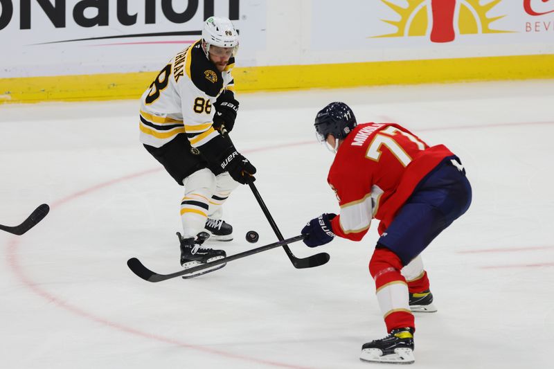 Oct 8, 2024; Sunrise, Florida, USA; Boston Bruins right wing David Pastrnak (88) moves the puck as Florida Panthers defenseman Niko Mikkola (77) defends during the third period at Amerant Bank Arena. Mandatory Credit: Sam Navarro-Imagn Images