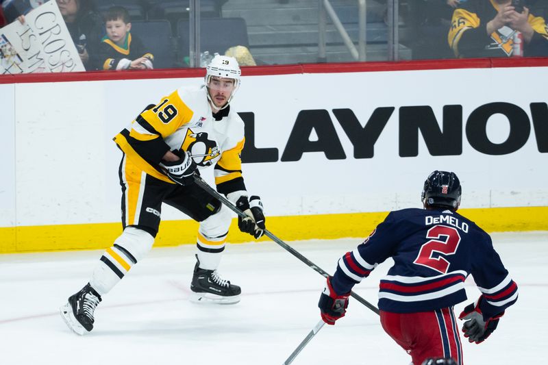 Feb 10, 2024; Winnipeg, Manitoba, CAN;  Pittsburgh Penguins forward Reilly Smith (19) tries to make a pass by Winnipeg Jets defenseman Dylan DeMelo (2) during the third period at Canada Life Centre. Mandatory Credit: Terrence Lee-USA TODAY Sports