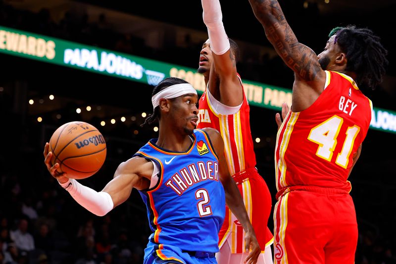 ATLANTA, GEORGIA - JANUARY 3: Shai Gilgeous-Alexander #2 of the Oklahoma City Thunder passes during the second quarter against the Atlanta Hawks at State Farm Arena on January 3, 2024 in Atlanta, Georgia. NOTE TO USER: User expressly acknowledges and agrees that, by downloading and or using this photograph, User is consenting to the terms and conditions of the Getty Images License Agreement. (Photo by Todd Kirkland/Getty Images)