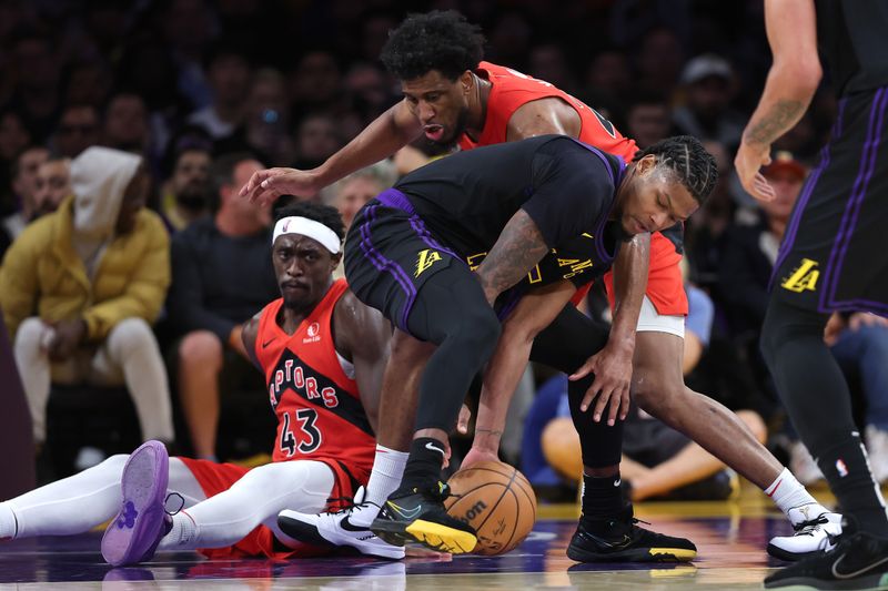 LOS ANGELES, CALIFORNIA - JANUARY 09: Pascal Siakam #43 and Thaddeus Young #21 of the Toronto Raptors battle for a loose ball against Cam Reddish #5 of the Los Angeles Lakers during the second half of a game at Crypto.com Arena on January 09, 2024 in Los Angeles, California.  NOTE TO USER: User expressly acknowledges and agrees that, by downloading and or using this photograph, User is consenting to the terms and conditions of the Getty Images License Agreement. (Photo by Sean M. Haffey/Getty Images)