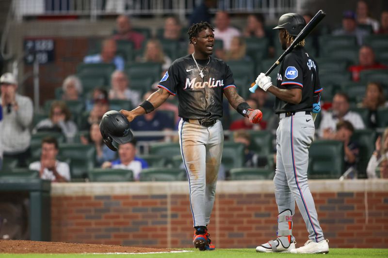 Apr 24, 2024; Atlanta, Georgia, USA; Miami Marlins center fielder Jazz Chisholm Jr. (2) reacts after being tagged out at home against the Atlanta Braves in the ninth inning at Truist Park. Mandatory Credit: Brett Davis-USA TODAY Sports