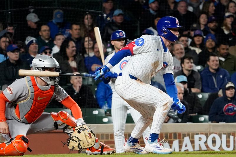 May 5, 2025; Chicago, Illinois, USA; Chicago Cubs outfielder Pete Crow-Armstrong (4) hits a single against the San Francisco Giants during the sixth inning at Wrigley Field. Mandatory Credit: David Banks-Imagn Images