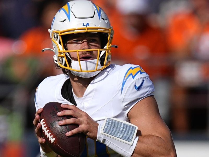 Los Angeles Chargers quarterback Justin Herbert (10) looks to pass during the first half of an NFL football game against the Denver Broncos, Sunday, Oct. 13, 2024, in Denver. (AP Photo/David Zalubowski)