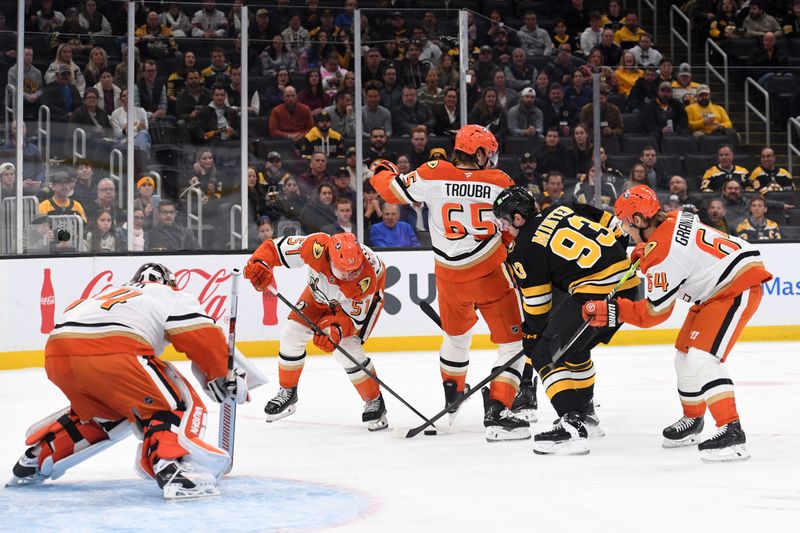 Oct 23, 2025; Boston, Massachusetts, USA; Anaheim Ducks defenseman Olen Zellweger (51) and Boston Bruins center Fraser Minten (93) battle for the puck during the first period at TD Garden. Mandatory Credit: Bob DeChiara-Imagn Images