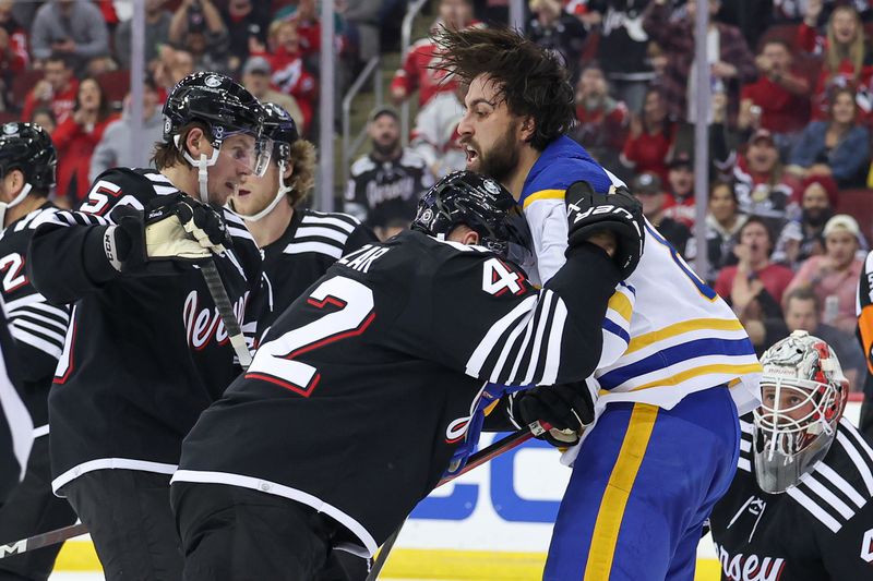 Oct 27, 2023; Newark, New Jersey, USA; New Jersey Devils center Curtis Lazar (42) battles against Buffalo Sabres right wing Alex Tuch (89) during the second period at Prudential Center. Mandatory Credit: Vincent Carchietta-USA TODAY Sports