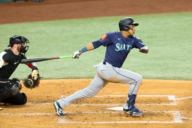Jun 27, 2025; Arlington, Texas, USA;  Seattle Mariners designated hitter Jorge Polanco (7) hits an rbi fielder's choice during the third inning against the Texas Rangers at Globe Life Field. Mandatory Credit: Kevin Jairaj-Imagn Images