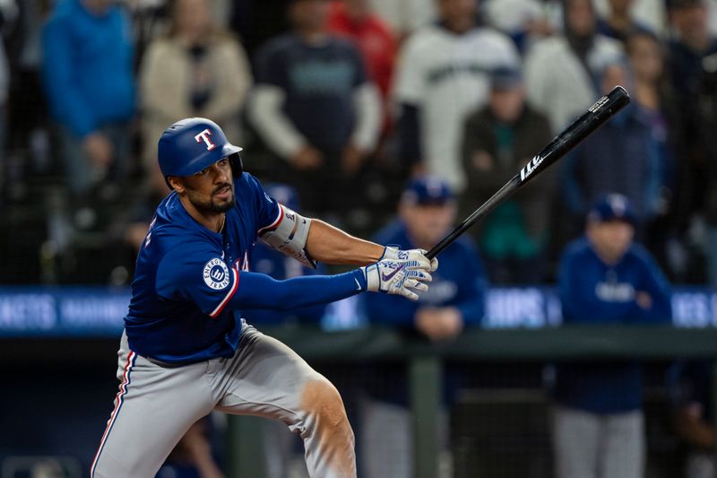 Jun 15, 2024; Seattle, Washington, USA; Texas Rangers second baseman Marcus Semien (2) hits a two-run single during the ninth inning against the Seattle Mariners at T-Mobile Park. Mandatory Credit: Stephen Brashear-USA TODAY Sports