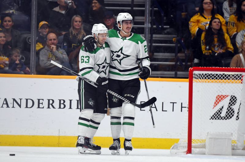 Dec 23, 2023; Nashville, Tennessee, USA; Dallas Stars right wing Evgenii Dadonov (63) and left wing Mason Marchment (27) celebrate after a goal during the third period against the Nashville Predators at Bridgestone Arena. Mandatory Credit: Christopher Hanewinckel-USA TODAY Sports