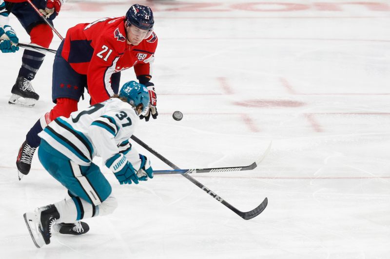 Dec 3, 2024; Washington, District of Columbia, USA; Washington Capitals center Aliaksei Protas (21) and San Jose Sharks defenseman Timothy Liljegren (37) battle for the puck in the first period at Capital One Arena. Mandatory Credit: Geoff Burke-Imagn Images