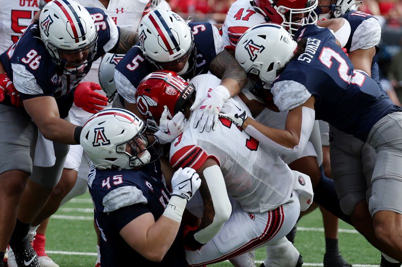 Nov 18, 2023; Tucson, Arizona, USA; Utah Utes running back Ja'Quinden Jackson (3) is tackled by Arizona Wildcats defensive lineman Bill Norton (45) and linebacker Jacob Manu (5) during the first half at Arizona Stadium. Mandatory Credit: Zachary BonDurant-USA TODAY Sports