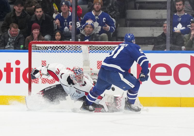 Dec 6, 2024; Toronto, Ontario, CAN; Toronto Maple Leafs center John Tavares (91) scores a goal on Washington Capitals goaltender Charlie Lindgren (79) during the second period at Scotiabank Arena. Mandatory Credit: Nick Turchiaro-Imagn Images