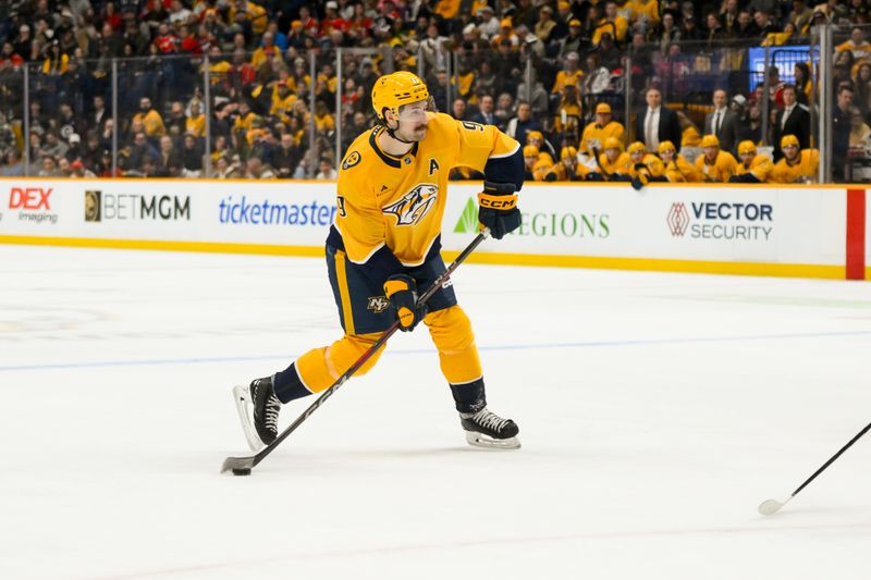 Jan 16, 2025; Nashville, Tennessee, USA;  Nashville Predators left wing Filip Forsberg (9) takes a shot on goal against the Chicago Blackhawks during the first period at Bridgestone Arena. Mandatory Credit: Steve Roberts-Imagn Images