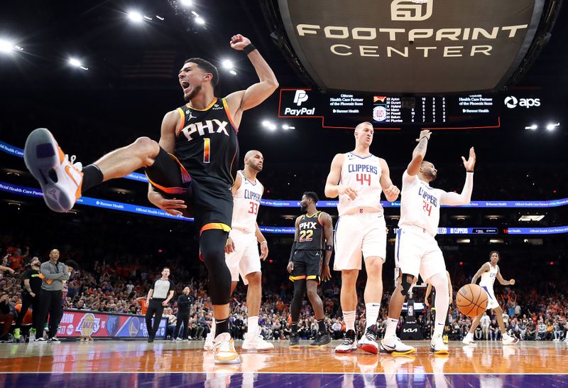 PHOENIX, ARIZONA - APRIL 25: Devin Booker #1 of the Phoenix Suns reacts after dunking the ball during the third quarter against the LA Clippers in game five of the Western Conference First Round Playoffs at Footprint Center on April 25, 2023 in Phoenix, Arizona. NOTE TO USER: User expressly acknowledges and agrees that, by downloading and or using this photograph, User is consenting to the terms and conditions of the Getty Images License Agreement. (Photo by Christian Petersen/Getty Images)