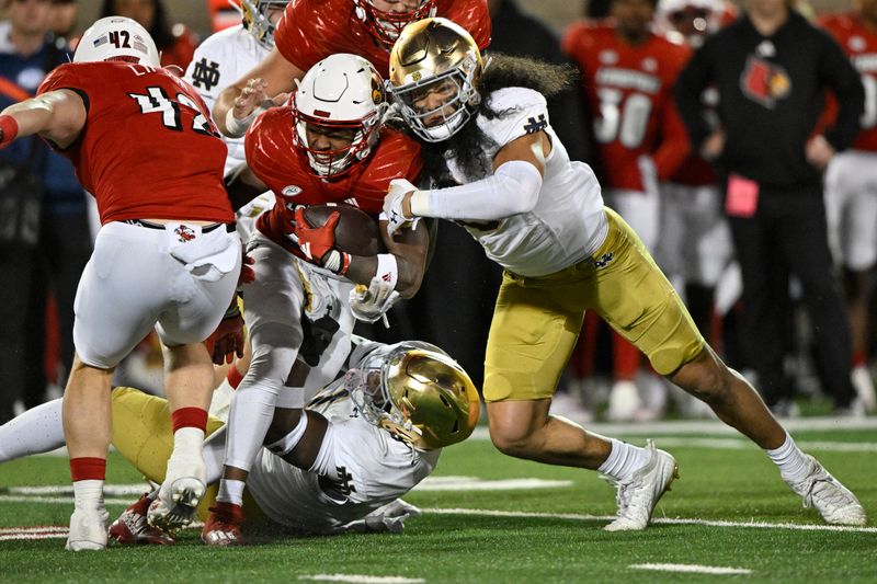 Oct 7, 2023; Louisville, Kentucky, USA; Notre Dame Fighting Irish defensive lineman Javontae Jean-Baptiste (1) tackles Louisville Cardinals running back Jawhar Jordan (25) during the second half at L&N Federal Credit Union Stadium. Louisville defeated Notre Dame 33-20. Mandatory Credit: Jamie Rhodes-USA TODAY Sports