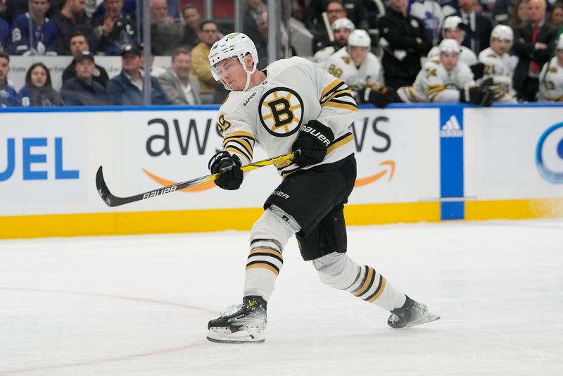 Apr 24, 2024; Toronto, Ontario, CAN; Boston Bruins forward Morgan Geekie (39) shoots the puck against the Toronto Maple Leafs during the second period of game three of the first round of the 2024 Stanley Cup Playoffs at Scotiabank Arena. Mandatory Credit: John E. Sokolowski-USA TODAY Sports