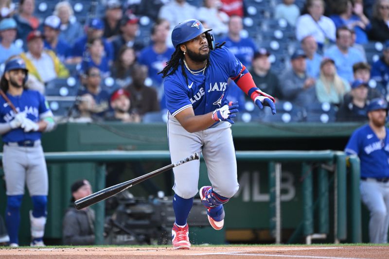 May 3, 2024; Washington, District of Columbia, USA; Toronto Blue Jays first baseman Vladimir Guerrero Jr. (27) watches the ball after a hit against the Washington Nationals during the first inning at Nationals Park. Mandatory Credit: Rafael Suanes-USA TODAY Sports