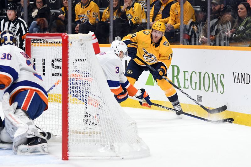 Jan 13, 2024; Nashville, Tennessee, USA; Nashville Predators center Gustav Nyquist (14) passes the puck from behind the net during the first period against the New York Islanders at Bridgestone Arena. Mandatory Credit: Christopher Hanewinckel-USA TODAY Sports