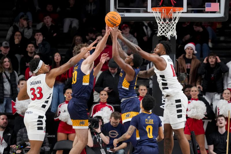 Dec 19, 2023; Cincinnati, Ohio, USA; Cincinnati Bearcats forward Jamille Reynolds (13) battles for the rebound against Merrimack Warriors guard Devon Savage (5) as forward Jacob O'Connell (20) reaches against Cincinnati Bearcats forward Ody Oguama (33) in the second half at Fifth Third Arena. Mandatory Credit: Aaron Doster-USA TODAY Sports