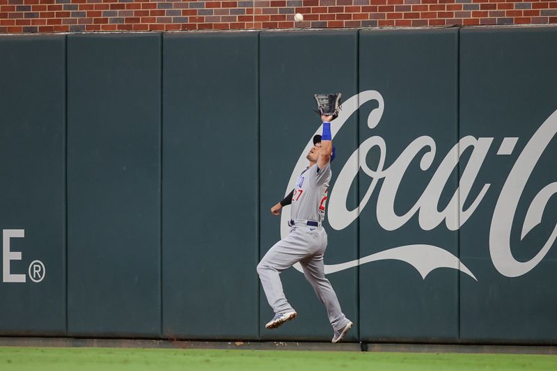 Sep 28, 2023; Atlanta, Georgia, USA; Chicago Cubs right fielder Seiya Suzuki (27) catches a fly ball against the Atlanta Braves in the second inning at Truist Park. Mandatory Credit: Brett Davis-USA TODAY Sports