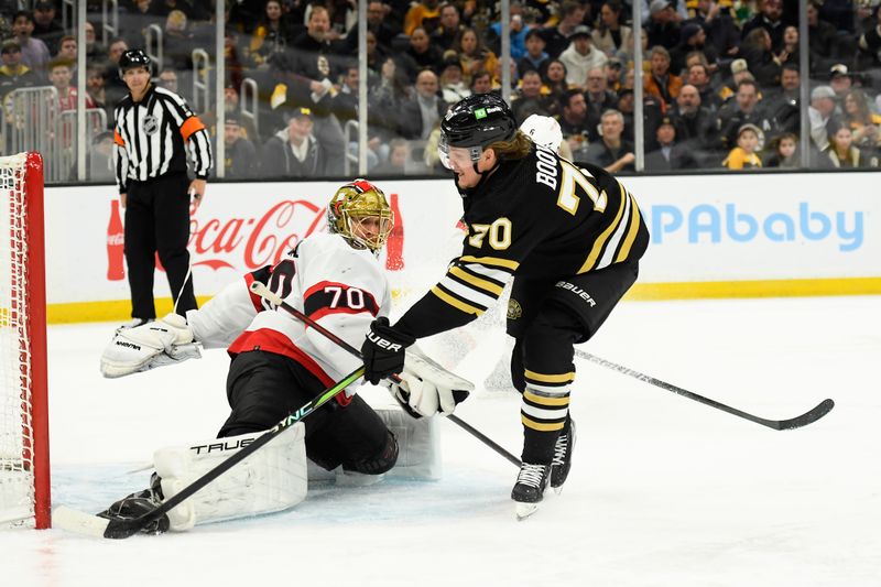 Mar 19, 2024; Boston, Massachusetts, USA;  Boston Bruins center Jesper Boqvist (70) tucks the puck past Ottawa Senators goaltender Joonas Korpisalo (70) during the third period at TD Garden. Mandatory Credit: Bob DeChiara-USA TODAY Sports