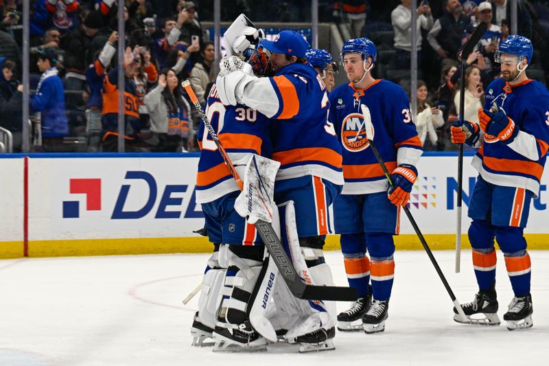 Jan 6, 2026; Elmont, New York, USA;  New York Islanders goaltender David Rittich (33) celebrates the 9-0 shut out by New York Islanders goaltender Ilya Sorokin (30) giving New York Islanders goaltender Ilya Sorokin (30) the most shut outs by an New York Islander against the New Jersey Devils after the game at UBS Arena. Mandatory Credit: Dennis Schneidler-Imagn Images