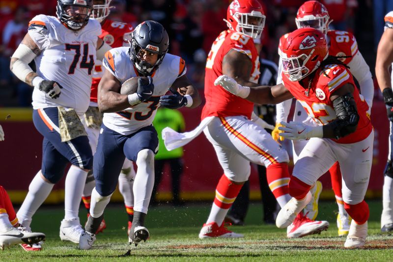 Denver Broncos running back Audric Estime (23) is chased by Kansas City Chiefs linebacker Nick Bolton (32) during the second half of an NFL football game, Sunday, Nov. 10, 2024 in Kansas City, Mo. The Chiefs defeated the Broncos, 16-14. (AP Photo/Reed Hoffmann)