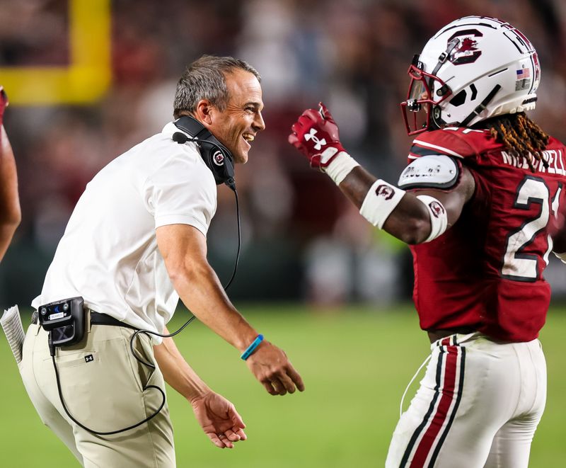 Sep 24, 2022; Columbia, South Carolina, USA; South Carolina Gamecocks head coach Shane Beamer celebrates a touchdown by South Carolina Gamecocks running back Juju McDowell (21) in the second half at Williams-Brice Stadium. Mandatory Credit: Jeff Blake-USA TODAY Sports