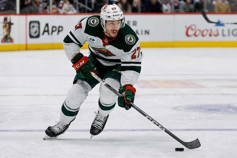 Mar 8, 2024; Denver, Colorado, USA; Minnesota Wild center Jacob Lucchini (27) controls the puck in the third period against the Colorado Avalanche at Ball Arena. Mandatory Credit: Isaiah J. Downing-USA TODAY Sports