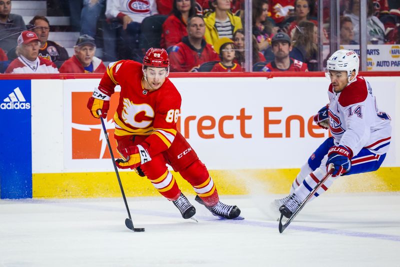 Mar 16, 2024; Calgary, Alberta, CAN; Calgary Flames left wing Andrew Mangiapane (88) controls the puck against Montreal Canadiens center Nick Suzuki (14) during the first period at Scotiabank Saddledome. Mandatory Credit: Sergei Belski-USA TODAY Sports