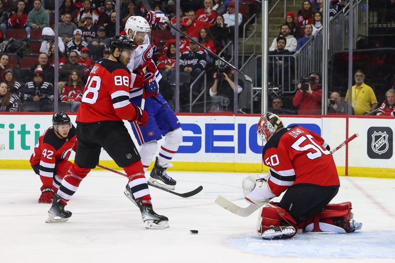 Jan 17, 2024; Newark, New Jersey, USA; New Jersey Devils goaltender Nico Daws (50) makes a save against the Montreal Canadiens during the third period at Prudential Center. Mandatory Credit: Ed Mulholland-USA TODAY Sports