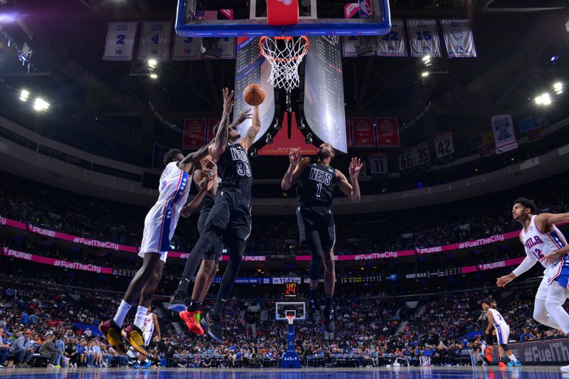 PHILADELPHIA, PA - APRIL 14: Nicolas Claxton #33 of the Brooklyn Nets rebounds the ball during the game against the Philadelphia 76ers on April 14, 2024 at the Wells Fargo Center in Philadelphia, Pennsylvania NOTE TO USER: User expressly acknowledges and agrees that, by downloading and/or using this Photograph, user is consenting to the terms and conditions of the Getty Images License Agreement. Mandatory Copyright Notice: Copyright 2024 NBAE (Photo by Jesse D. Garrabrant/NBAE via Getty Images)
