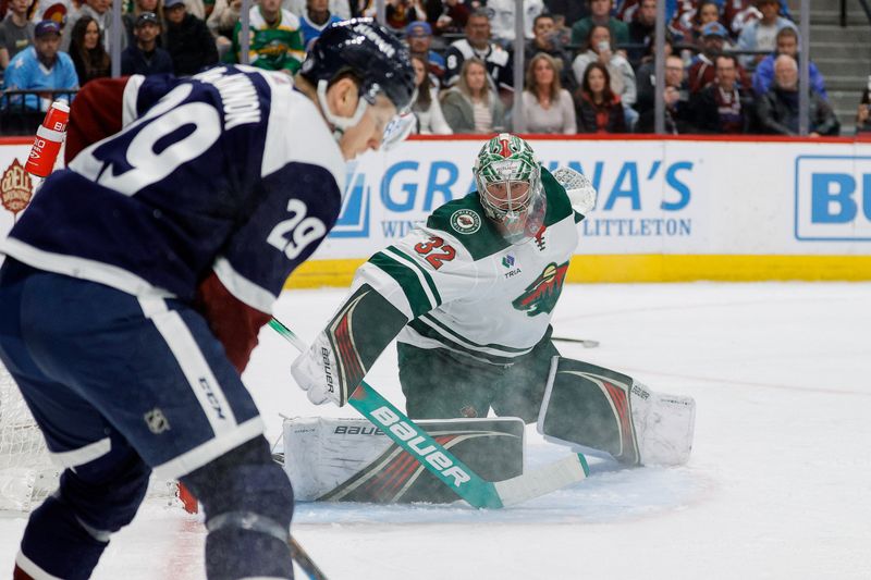 Apr 9, 2024; Denver, Colorado, USA; Minnesota Wild goaltender Filip Gustavsson (32) watches as Colorado Avalanche center Nathan MacKinnon (29) controls the puck in the second period at Ball Arena. Mandatory Credit: Isaiah J. Downing-USA TODAY Sports