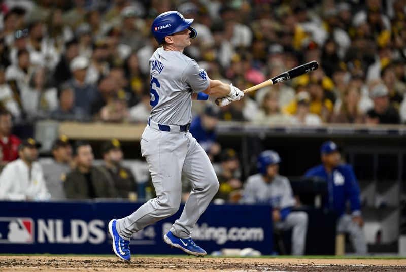 Oct 9, 2024; San Diego, California, USA; Los Angeles Dodgers catcher Will Smith (16) hits a two-run home run in the third inning against the San Diego Padres during game four of the NLDS for the 2024 MLB Playoffs at Petco Park.  Mandatory Credit: Denis Poroy-Imagn Images