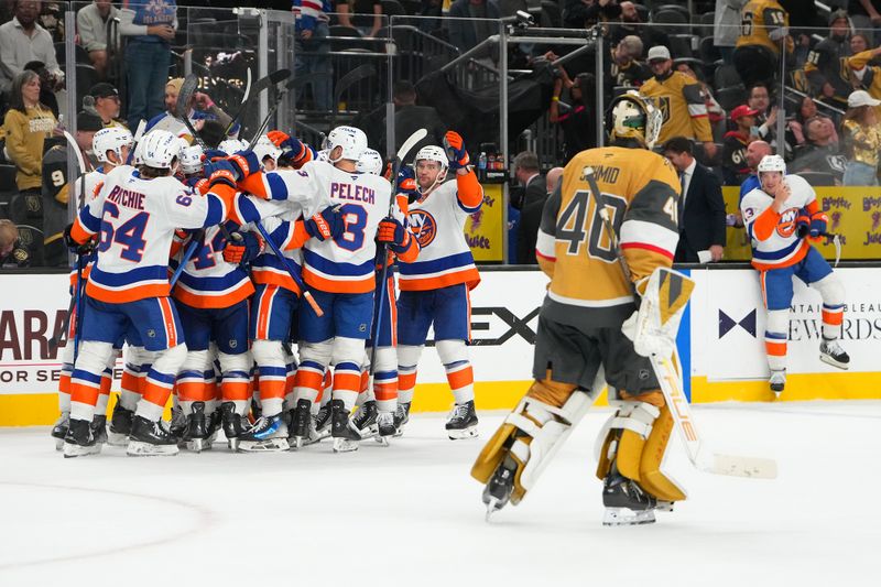 Nov 13, 2025; Las Vegas, Nevada, USA; New York Islanders center Jean-Gabriel Pageau (44) celebrates with team mates after scoring a short-handed goal against Vegas Golden Knights goaltender Akira Schmid (40) during an overtime period to give the Islanders a 4-3 victory at T-Mobile Arena. Mandatory Credit: Stephen R. Sylvanie-Imagn Images